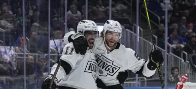 Los Angeles Kings' Adrian Kempe (9) celebrates with Anze Kopitar (11) after scoring a goal during the first period of an NHL hockey game against the New York Islanders Tuesday, Dec. 10, 2024, in Elmont, N.Y. (AP Photo/Frank Franklin II)