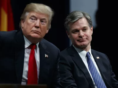 FILE - President Donald Trump sits with FBI Director Christopher Wray during the FBI National Academy graduation ceremony, Dec. 15, 2017, in Quantico, Va. (AP Photo/Evan Vucci, File)