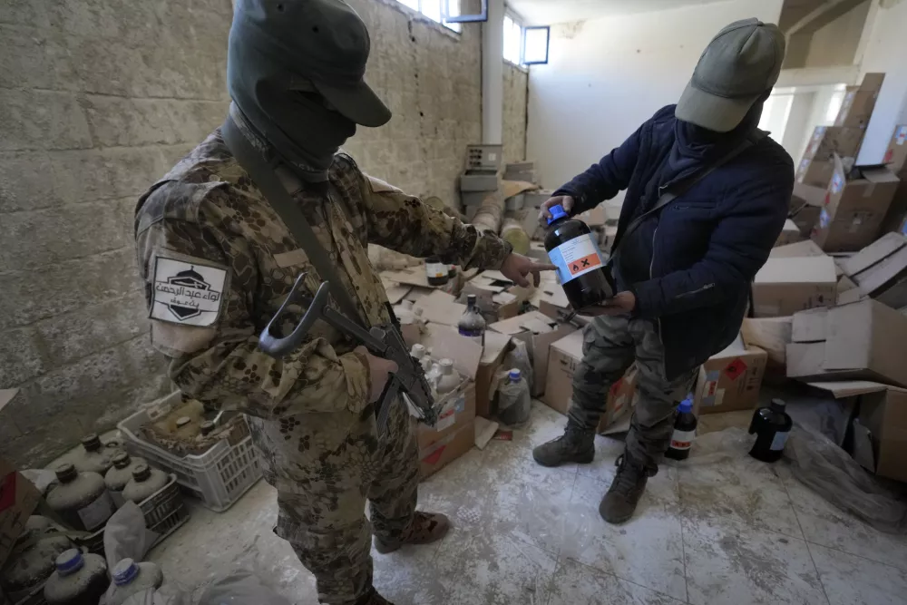 Syrian members of the rebel group show materials for manufacturing amphetamine pills, known as Captagon, at the warehouse where the drug was manufactured before the fall of Bashar Assad government at a facility in Douma city, outskirts of Damascus, Syria, Friday, Dec. 13, 2024. (AP Photo/Hussein Malla)