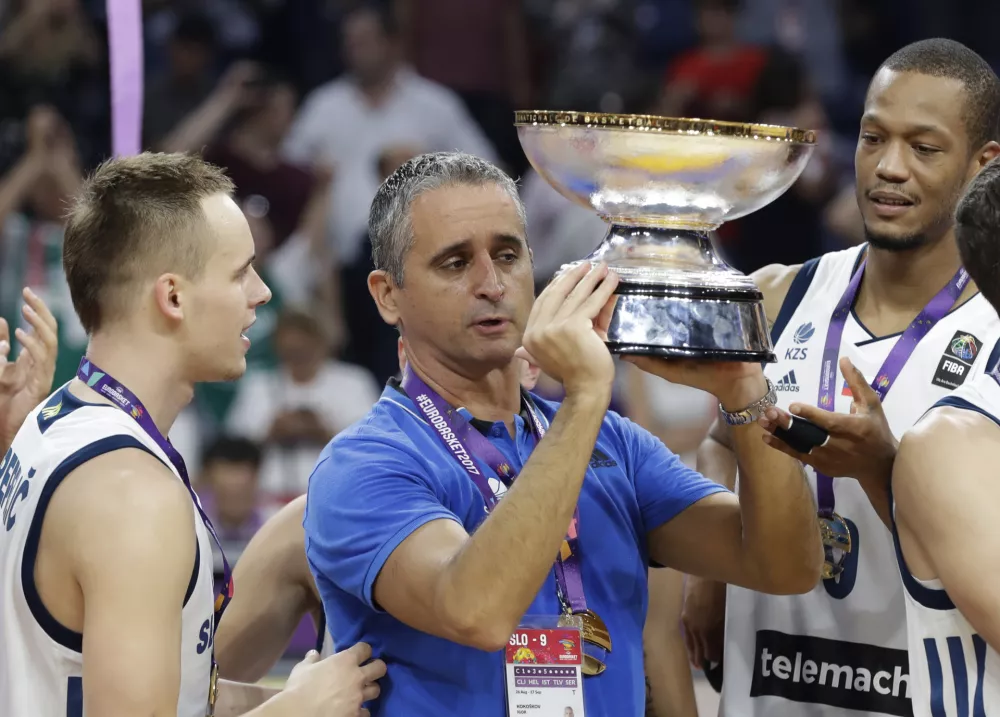 ﻿Slovenia's coach Igor Kokoskov, center, holds the trophy and celebrates after winning the Eurobasket European Basketball Championship final match against Serbia, in Istanbul, Sunday, Sept. 17. 2017. (AP Photo/Lefteris Pitarakis)