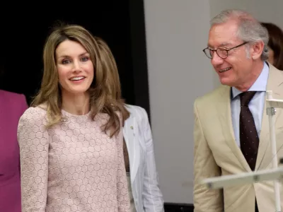 FILE PHOTO: Isak Andic, Chief Executive of Spanish fashion label Mango, stands next to Spanish Princess Letizia, during her visit to Mango's factory in Palau-Solita i Plegamans, near Barcelona, April 7, 2011. Andic died on Saturday in a mountain accident, the company said. He was 71. REUTERS/Albert Gea (SPAIN - Tags: ROYALS FASHION BUSINESS)/File Photo