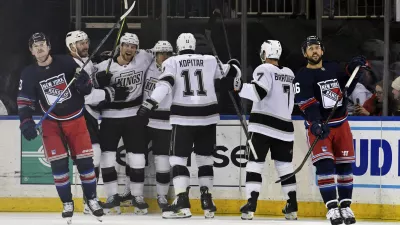 From left, Los Angeles Kings' Joel Edmundson, Andreas Englund, Alex Turcotte, Anze Kopitar and Kyle Burroughs celebrate as New York Rangers' Alexis Lafrenière, left, and Vincent Trocheck, right, react after Turcotte scored during the first period of an NHL hockey game, Saturday, Dec. 14, 2024, in New York. (AP Photo/Pamela Smith)