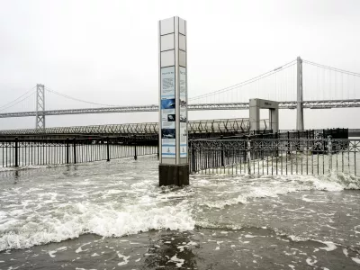 Water from the San Francisco Bay spills onto the Embarcadero in San Francisco on Saturday, Dec. 14, 2024, as a result of high tides and storm-driven waves. (AP Photo/Noah Berger)