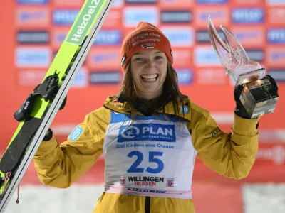 FILED - 03 February 2024, Hesse, Willingen: Katharina Schmid from Germany celebrates at the award ceremony of the women's Nordic skiing during the Ski Jumping World Cup. Schmid extended her overall lead after winning a women's normal hill World Cup ski-jumping event in the 2022 Winter Olympic venue of Zhangjiakou, China on 13 December. Photo: Swen Pförtner/dpa