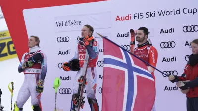 Norway's Henrik Kristoffersen, center, winner of an alpine ski, men's World Cup slalom, poses on podium with second placed Norway's Atle Lie McGrath, left, and third placed Switzerland's Loic Meillard, in Val d'Isere, France, Sunday, Dec.15, 2024.(AP Photo/Giovanni Auletta)