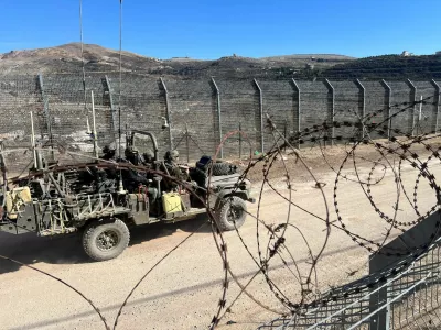 Israeli soldiers ride in a military vehicle along the ceasefire line with Syria and the Israeli-occupied Golan Heights, as seen from the Golan Heights, December 15, 2024. REUTERS/Avi Ohayon