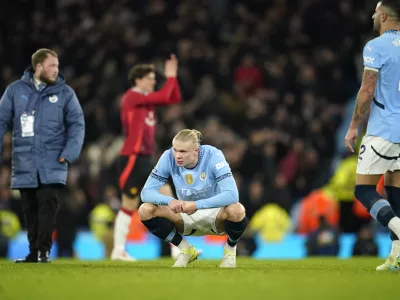 Manchester City's Erling Haaland, centre, reacts disappointed after the English Premier League soccer match between Manchester City and Manchester United at the Etihad Stadium in Manchester, Sunday, Dec. 15, 2024. (AP Photo/Dave Thompson)