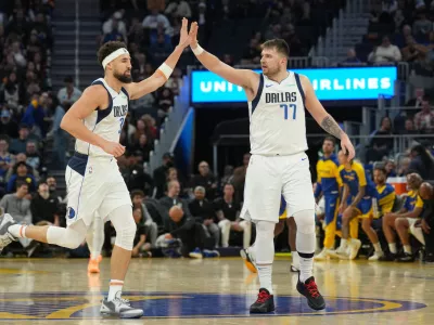 Dec 15, 2024; San Francisco, California, USA; Dallas Mavericks guard Klay Thompson (left) is congratulated by guard Luka Doncic (77) after scoring against the Golden State Warriors during the third quarter at Chase Center. Mandatory Credit: Darren Yamashita-Imagn Images