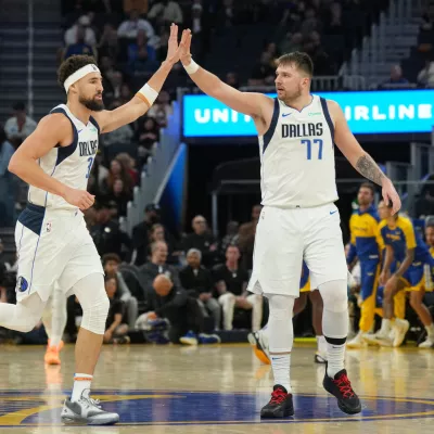 Dec 15, 2024; San Francisco, California, USA; Dallas Mavericks guard Klay Thompson (left) is congratulated by guard Luka Doncic (77) after scoring against the Golden State Warriors during the third quarter at Chase Center. Mandatory Credit: Darren Yamashita-Imagn Images