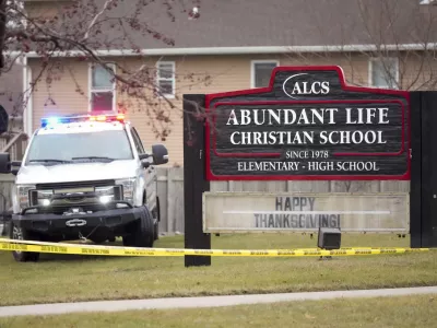 Emergency vehicles are parked outside the Abundant Life Christian School in Madison, Wis., following a shooting, Monday, Dec. 16, 2024. (AP Photo/Morry Gash)