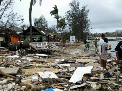 (150315) -- PORT VILA, March 15, 2015 (Xinhua) -- Locals walk past debris after Tropical Cyclone Pam wreaked havoc in Port Vila, Vanuatu, March 15, 2015. The cyclone-hit island nation of Vanuatu declared a state of emergency on Sunday after at least eight people were confirmed killed by Tropical Cyclone Pam, local press reported.(Xinhua/Luo Xiangfeng)(dh)