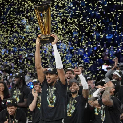 Dec 17, 2024; Las Vegas, Nevada, USA; Milwaukee Bucks forward Giannis Antetokounmpo (34) celebrates with the trophy and teammates after winning the Emirates NBA Cup championship game against the Oklahoma City Thunder at T-Mobile Arena. Mandatory Credit: Kyle Terada-Imagn Images