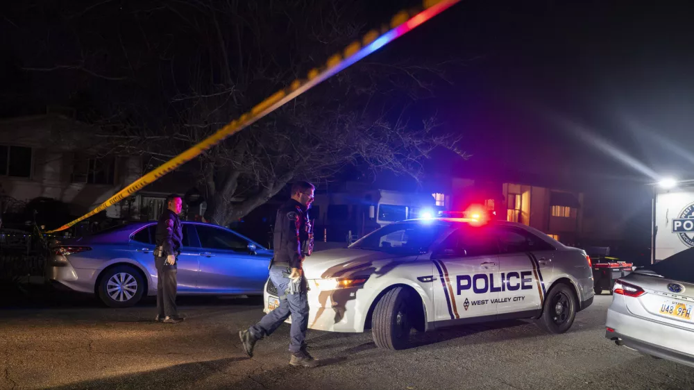 Police investigate a crime scene where they say multiple family members were found dead inside a home in West Valley City, Utah, Tuesday Dec. 17, 2024. (Scott G. Winterton/The Deseret News via AP)