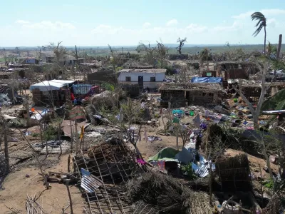 People stand amid destroyed buildings, uprooted trees and debris after cyclone Chido hit Mozambique, in Mecufi district, Cabo Delgado province, Mozambique, December 16, 2024, in this screengrab taken from a handout drone video. Unicef Mozambique/Handout via REUTERS  THIS IMAGE HAS BEEN SUPPLIED BY A THIRD PARTY NO RESALES. NO ARCHIVES. MANDATORY CREDIT