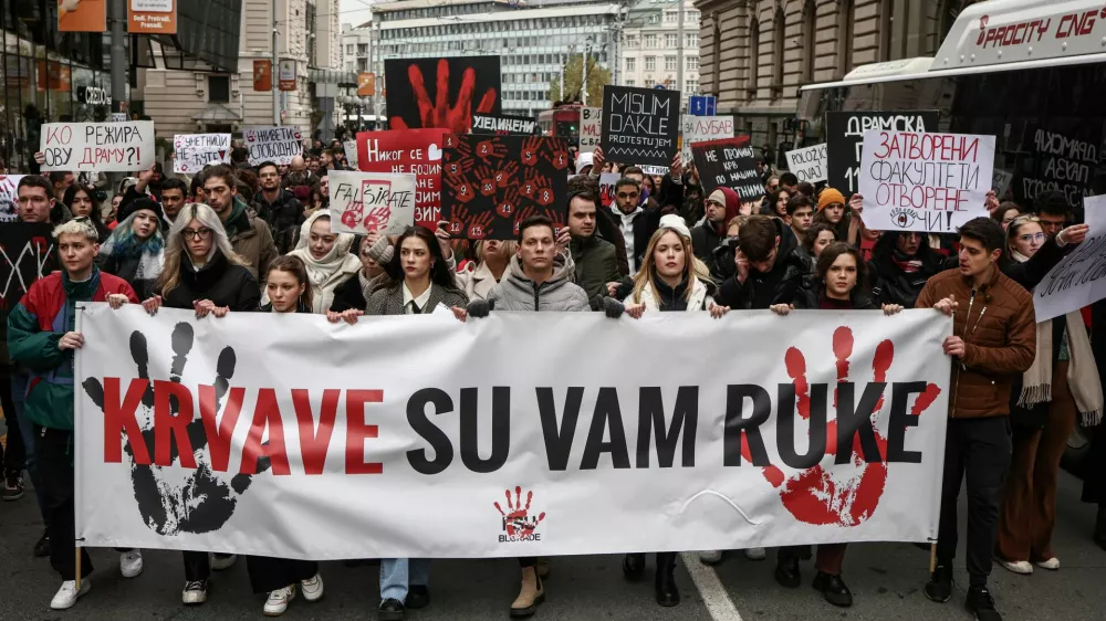 Students of Belgrade University block the street for fifteen minutes to pay their respect for fifteen victims of a fatal roof collapse at Novi Sad's railway station in Belgrade, Serbia, December 13, 2024. REUTERS/Marko Djurica