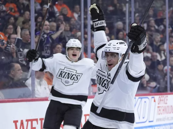 Los Angeles Kings' Anze Kopitar, right, celebrates after scoring a goal during the third period of an NHL hockey game against the Philadelphia Flyers, Thursday, Dec. 19, 2024, in Philadelphia. (AP Photo/Matt Slocum)