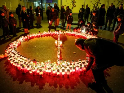 People lay candles following a knife attack in a primary school, in Zagreb, Croatia, December 20, 2024. REUTERS/Antonio Bronic