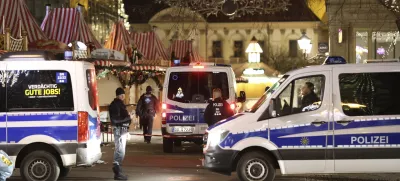 Police officers and police emergency vehicles are seen at the Christmas market in Magdeburg after a driver plowed into a busy Christmas market in Magdeburg, Germany, Saturday, Dec. 21, 2024. (Matthias Bein/dpa via AP)