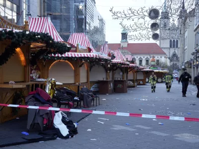 Police and firefighters walk at a cordoned-off Christmas Market, where a car drove into a crowd on Friday evening, in Magdeburg, Germany, Saturday, Dec. 21, 2024. (AP Photo/Michael Probst)