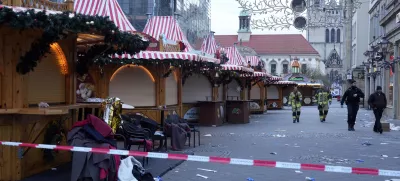 Police and firefighters walk at a cordoned-off Christmas Market, where a car drove into a crowd on Friday evening, in Magdeburg, Germany, Saturday, Dec. 21, 2024. (AP Photo/Michael Probst)