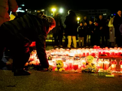 A person lays a candle following a knife attack in a primary school, in Zagreb, Croatia, December 20, 2024. REUTERS/Antonio Bronic