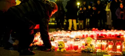 A person lays a candle following a knife attack in a primary school, in Zagreb, Croatia, December 20, 2024. REUTERS/Antonio Bronic