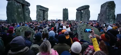 20 December 2024, United Kingdom, Wiltshire: People take part in the winter solstice celebrations during sunrise at the Stonehenge prehistoric monument on Salisbury Plain in Wiltshire. Photo: Andrew Matthews/PA Wire/dpa