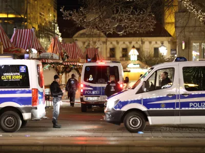 21 December 2024, Saxony-Anhalt, Magdeburg: Police emergency vehicles are stationed in front of the Christmas market in Magdeburg. Almost eight years to the day after the terrorist attack on the Berlin Christmas market at the Memorial Church, a man drives into a crowd of people in Magdeburg. Photo: Matthias Bein/dpa