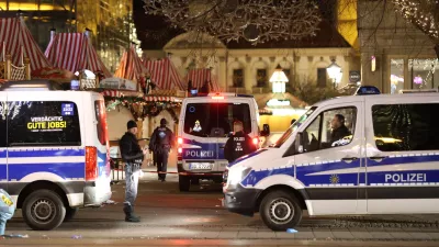 21 December 2024, Saxony-Anhalt, Magdeburg: Police emergency vehicles are stationed in front of the Christmas market in Magdeburg. Almost eight years to the day after the terrorist attack on the Berlin Christmas market at the Memorial Church, a man drives into a crowd of people in Magdeburg. Photo: Matthias Bein/dpa