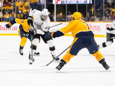 Dec 21, 2024; Nashville, Tennessee, USA; Los Angeles Kings center Anze Kopitar (11) skates with the puck as Nashville Predators defenseman Jeremy Lauzon (3) defends during the second period at Bridgestone Arena. Mandatory Credit: Steve Roberts-Imagn Images