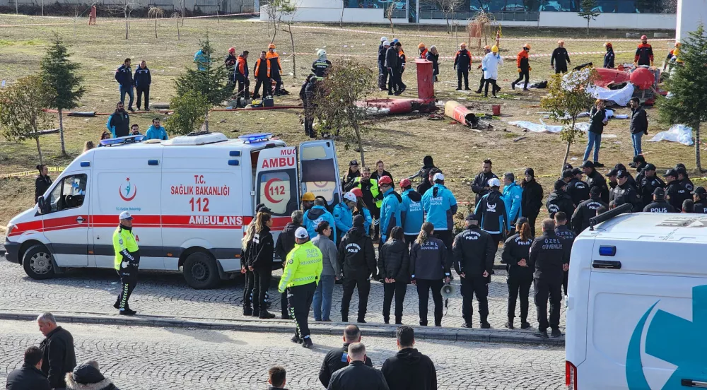 Members of emergency services gather as police forensic experts examine the wreckage of an ambulance helicopter after it collided with a hospital building and crashed into the ground, in Mugla, Turkey, December 22, 2024. REUTERS/Kenan Gurbuz