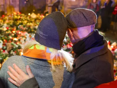 21 December 2024, Saxony-Anhalt, Magdeburg: People lay flowers and candles for the victims outside St. John's Church in Magdeburg, near the Christmas market where a driver rammed into a group of people on Friday evining. Photo: Jan Woitas/dpa