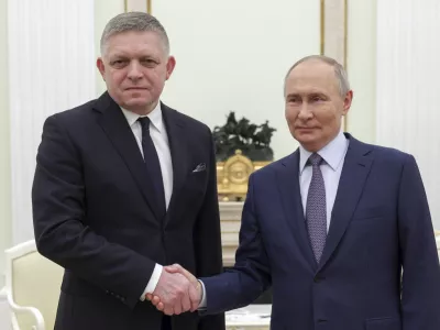 Russian President Vladimir Putin, right, and Slovak Prime Minister Robert Fico shake hands during their meeting at the Kremlin in Moscow, Russia, Sunday, Dec. 22, 2024. (Gavriil Grigorov, Sputnik, Kremlin Pool Photo via AP)