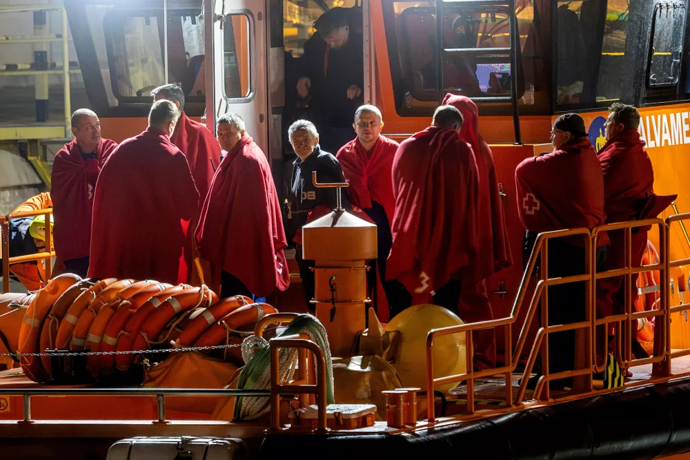 Survivors of the sinking of Russian cargo ship Ursa Major stand on the deck of a Spanish Maritime Rescue ship upon arrival at the port of Cartagena, Spain, December 23, 2024. REUTERS/Jose Maria Rodriguez   TPX IMAGES OF THE DAY