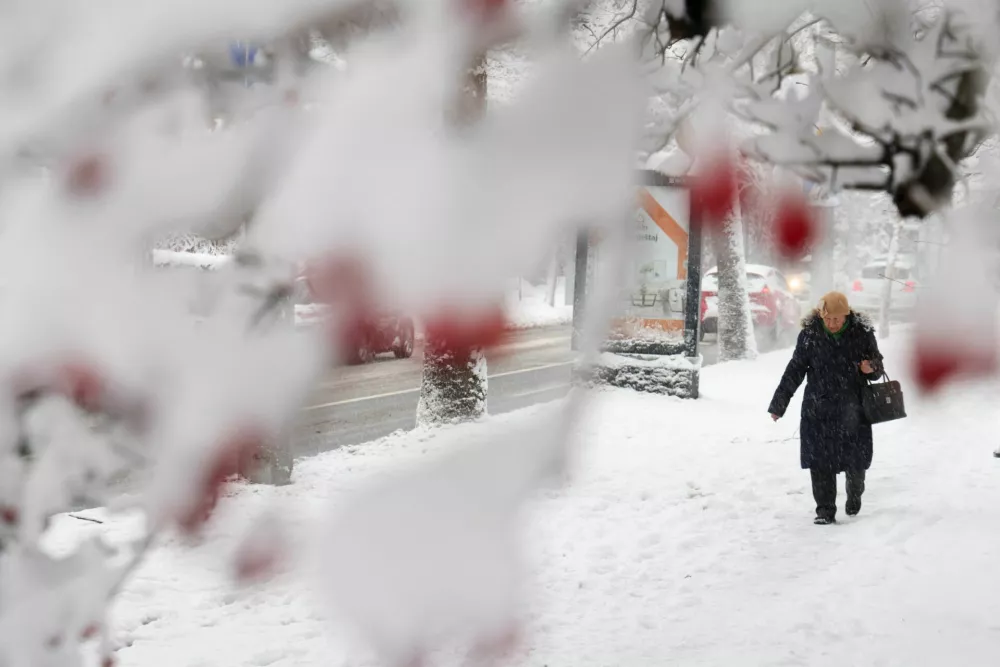 A woman walks on the street during snowstorm in Sarajevo, Bosnia and Herzegovina, December 24, 2024.REUTERS/Amel Emric