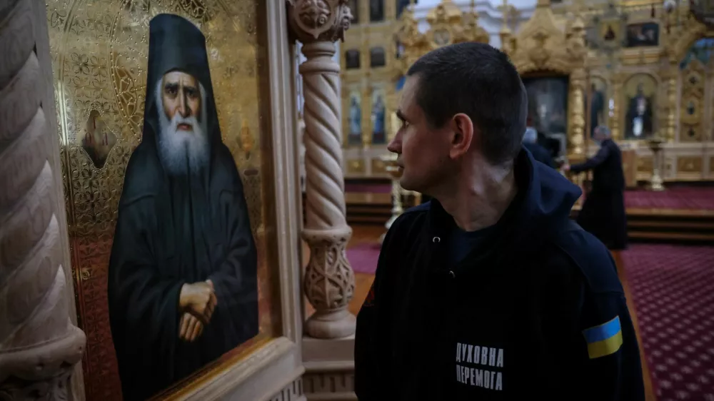 A recovering Ukrainian soldier looks at the icon of a saint inside the church of the Skete of Prophet Elijah in Mount Athos, Greece, November 26, 2024. In their four-day stay, part of a psychological support programme organised by Ukrainian authorities, the 22 soldiers made a pilgrimage to some dozen monasteries on the slopes of Mount Athos, a spiritual centre since the 10th century. "A lot of servicemen suffer from the events that took place over the last three years. A lot of them suffer from different illnesses – they are wounded, and we have to rehabilitate them," said Father Mykhailo Pasirskyi, a Ukrainian Orthodox priest. REUTERS/Alexandros Avramidis     SEARCH "AVRAMIDIS UKRAINE ATHOS" FOR THIS STORY. SEARCH "WIDER IMAGE" FOR ALL STORIES.