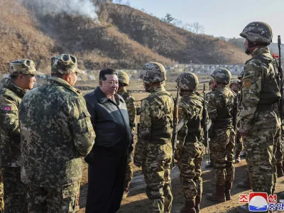 FILE - In this photo provided by the North Korean government, North Korean leader Kim Jong Un, center left, meets soldiers during a visit to a western operational training base in North Korea Wednesday, March 6, 2024. Independent journalists were not given access to cover the event depicted in this image distributed by the North Korean government. The content of this image is as provided and cannot be independently verified. Korean language watermark on image as provided by source reads: "KCNA" which is the abbreviation for Korean Central News Agency. (Korean Central News Agency/Korea News Service via AP, File)