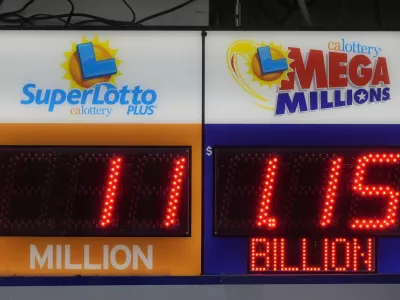 A sign advertising the estimated .15 billion Mega Millions jackpot, right, is displayed at Rossi's Deli in San Francisco, Thursday, Dec. 26, 2024. (AP Photo/Jeff Chiu)