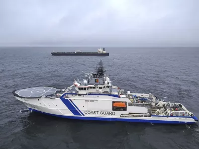 This photo provided by Rajavartiosto (Finnish Border Guard) on Thursday, Dec. 26, 2024, shows the oil tanker Eagle S, background, and the Finnish Border Guard ship Turva at sea outside Porkkalanniemi, Finland. The Eagle S was sailing at the same time in the area where the Finland-Estonia electrical link was disrupted on Wednesday. (Rajavartiosto via AP)