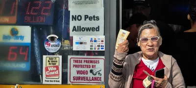 Diana Ramirez shows off her lottery tickets she bought at Joe's Service Center on Friday, Dec. 27, 2024 in Altadena, Calif. In 2022, the location had sold a .04 billion Powerball ticket. (AP Photo/Richard Vogel)