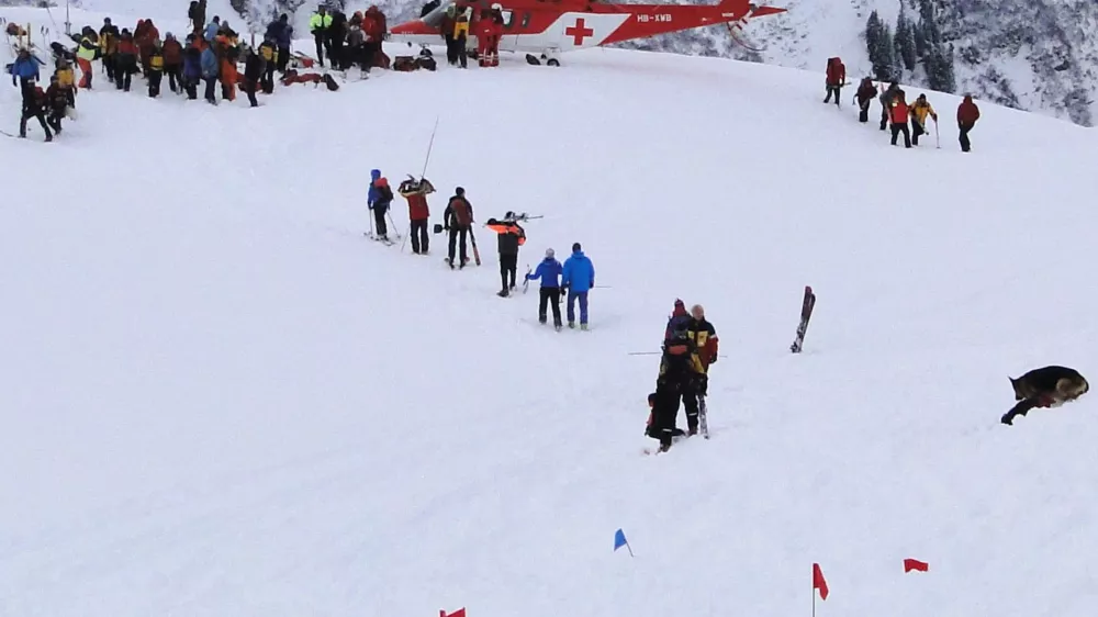 Rescue workers are seen at the site where two avalanches came down a mountainside in the Diemtig valley in the Bernese Oberland January 3, 2010. After a rescue team arrived on the scene, a second avalanche caught an unknown number of people involved in the search for a trapped skier on Sunday. The police said at least three other people are missing and believed to be buried under the snow from avalanches that killed three ski mountaineers and a doctor involved in the search and rescue operation after the first avalanche. Picture taken January 3, 2010. REUTERS/ Police of the canton Bern/Handout (SWITZERLAND - Tags: DISASTER ENVIRONMENT IMAGES OF THE DAY)