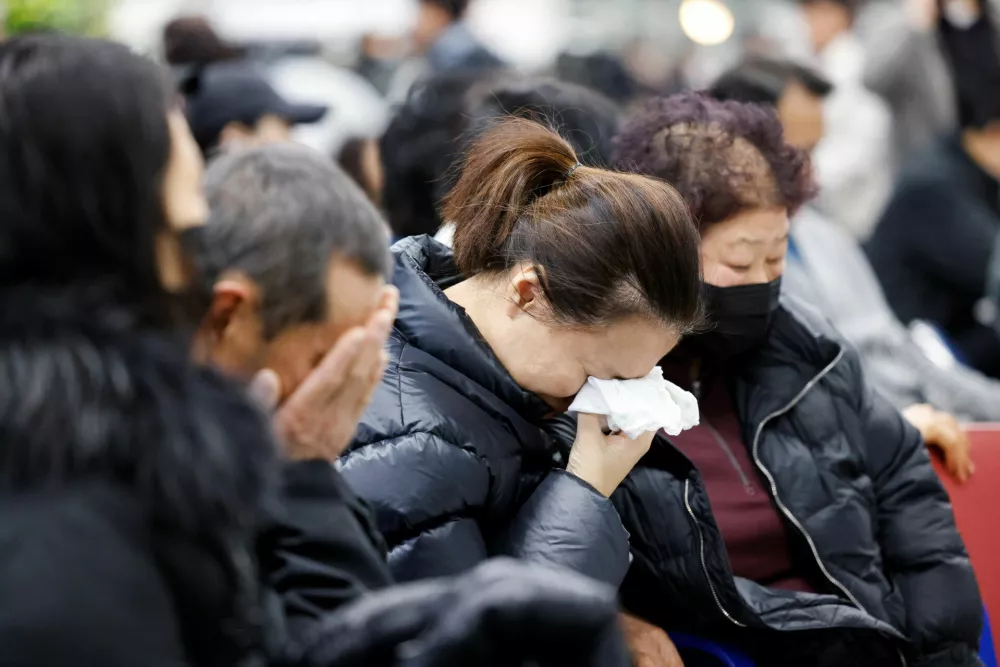 Relatives of passengers of the aircraft that crashed after it went off the runway, react at Muan International Airport, in Muan, South Korea, December 29, 2024. REUTERS/Kim Soo-hyeon