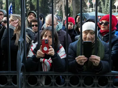 People gather outside the fence of the Orbeliani presidential palace before the address of outgoing Georgia's President Salome Zourabichvili to supporters and journalists on the day of the swearing-in ceremony of new Georgia's president Mikheil Kavelashvili, in Tbilisi, Georgia December 29, 2024. REUTERS/Daro Sulakauri