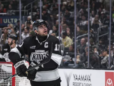 Los Angeles Kings center Anze Kopitar (11) looks up at the scoreboard after missing an empty net goal attempt during the third period of an NHL hockey game against the Philadelphia Flyers, Sunday, Dec. 29, 2024, in Los Angeles. (AP Photo/William Liang)