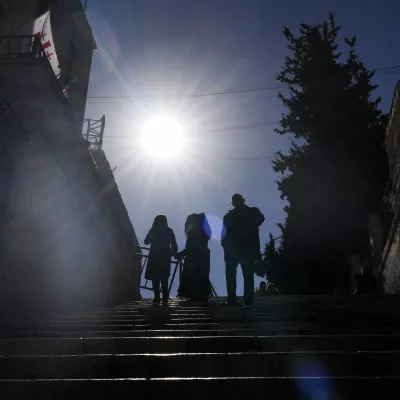 Worshippers walk down the stairs next to the Christmas morning Mass at the Chapel of Saint Catherine, traditionally believed to be the birthplace of Jesus, in the West Bank city of Bethlehem, Wednesday, Dec. 25, 2024. (AP Photo/Matias Delacroix)