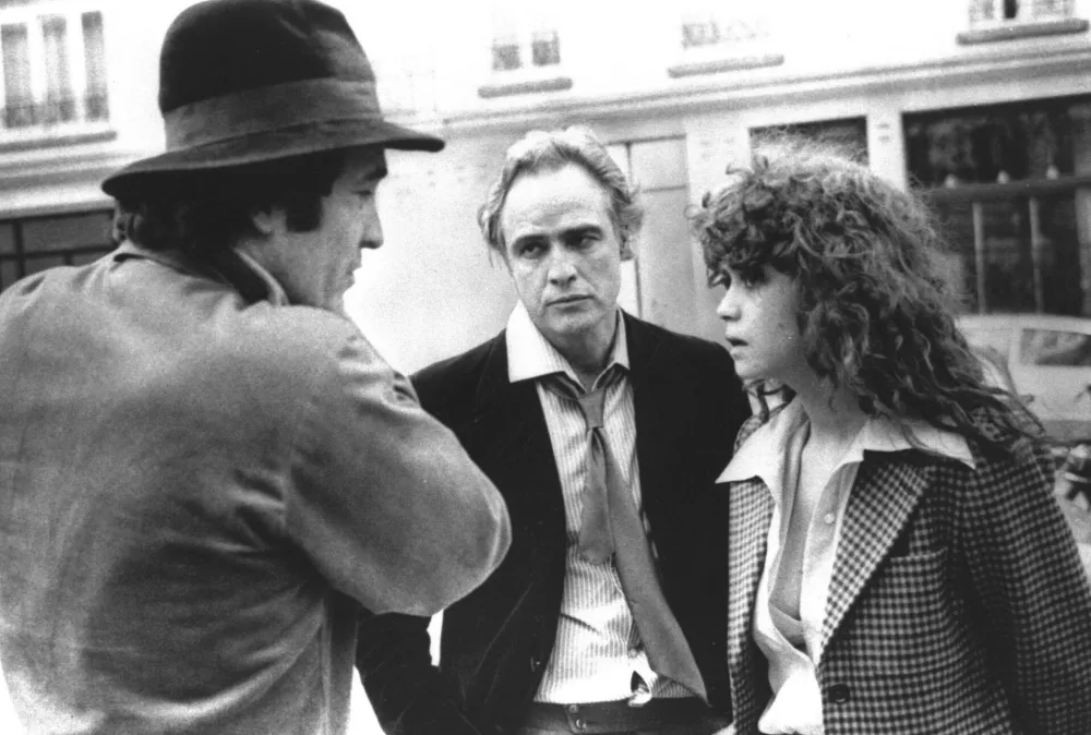 ﻿FILE -- Feb. 11, 1973 file photo Italian Director Bernardo Bertolucci, left, discusses a scene with leading actor Marlon Brando, center, and actress Maria Schneider during the shooting on the movie "Last Tango in Paris", in Paris, France. Bertolucci, who won Oscars with "The Last Emperor" and whose erotic drama "Last Tango in Paris" enthralled and shocked the world, has died at the age of 77. Bertolucci's press office, Punto e Virgola, confirmed the death Monday, Nov. 26, 2018, in an email to The Associated Press. (AP Photo)