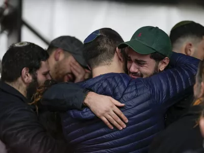 People attend the funeral of 1st Sgt. Yuval Shoham, who was killed in a battle in the Gaza Strip, during his burial at Mount Herzl military cemetery in Jerusalem, Monday, Dec. 30, 2024. (AP Photo/Matias Delacroix)