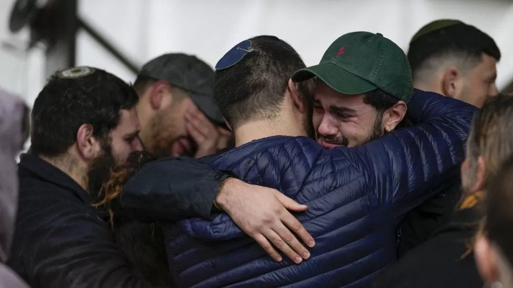 People attend the funeral of 1st Sgt. Yuval Shoham, who was killed in a battle in the Gaza Strip, during his burial at Mount Herzl military cemetery in Jerusalem, Monday, Dec. 30, 2024. (AP Photo/Matias Delacroix)