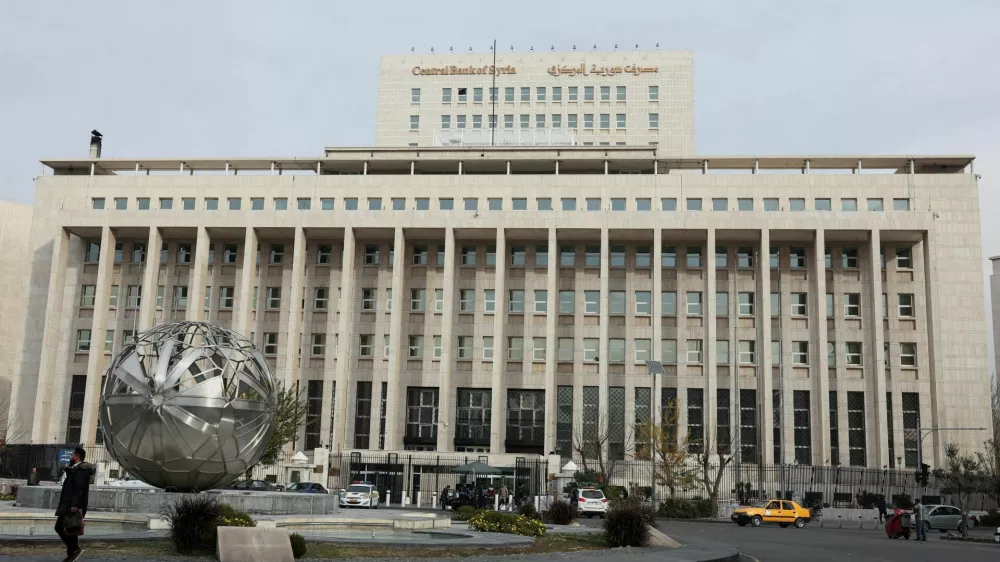 FILE PHOTO: People and cars are seen in front of the Central Bank of Syria, after rebels seized the capital and ousted Syria's Bashar al-Assad, in Damascus, Syria December 11, 2024. REUTERS/Amr Abdallah Dalsh/File Photo