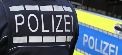 FILED - 03 December 2024, Baden-Württemberg, Stuttgart: A policeman is pictured next to a police car in Stuttgart. Photo: Bernd Weißbrod/dpa